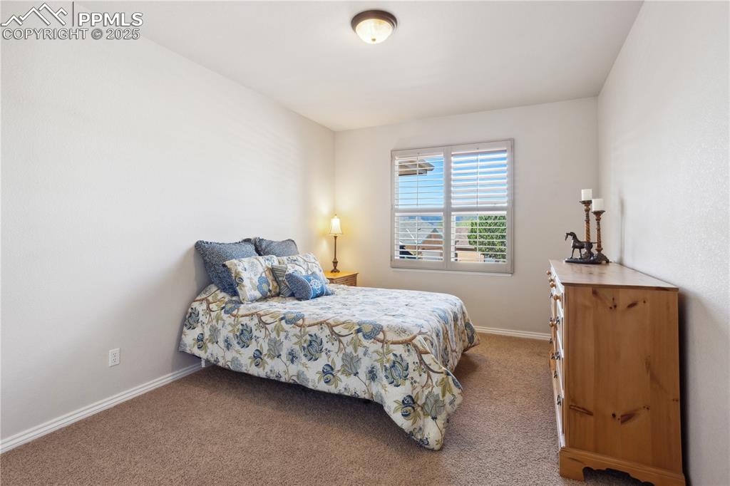 16243 Kitchener Way Monument, CO 80132 - Photo 14 of 33 a bedroom with a bed and a window
