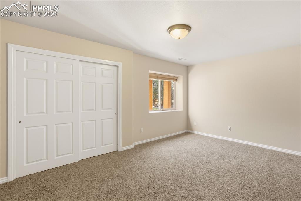16243 Kitchener Way Monument, CO 80132 - Photo 19 of 33 an empty room with windows