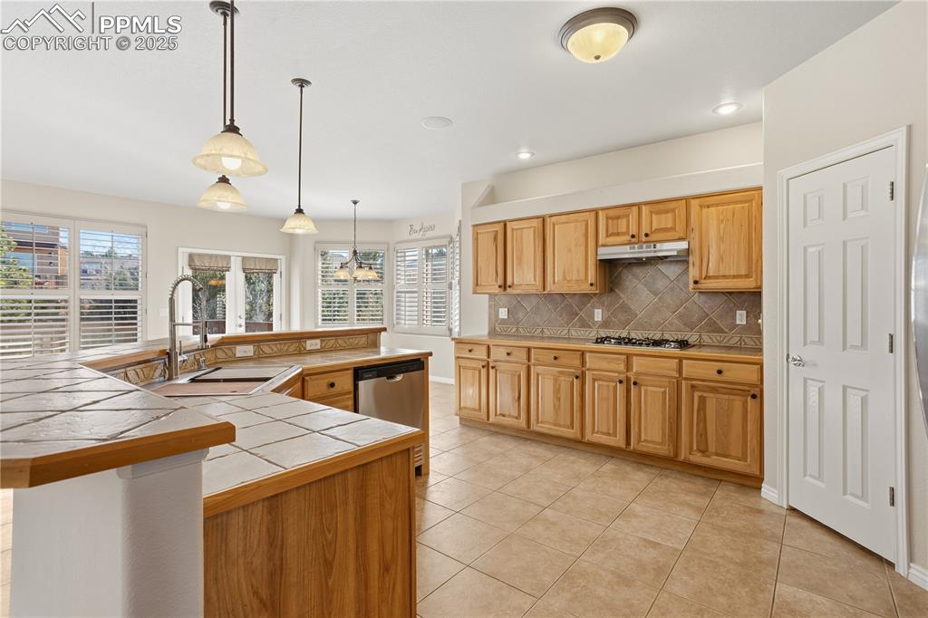 16243 Kitchener Way Monument, CO 80132 - Photo 5 of 33 a kitchen with granite countertop a sink a counter space appliances and cabinets