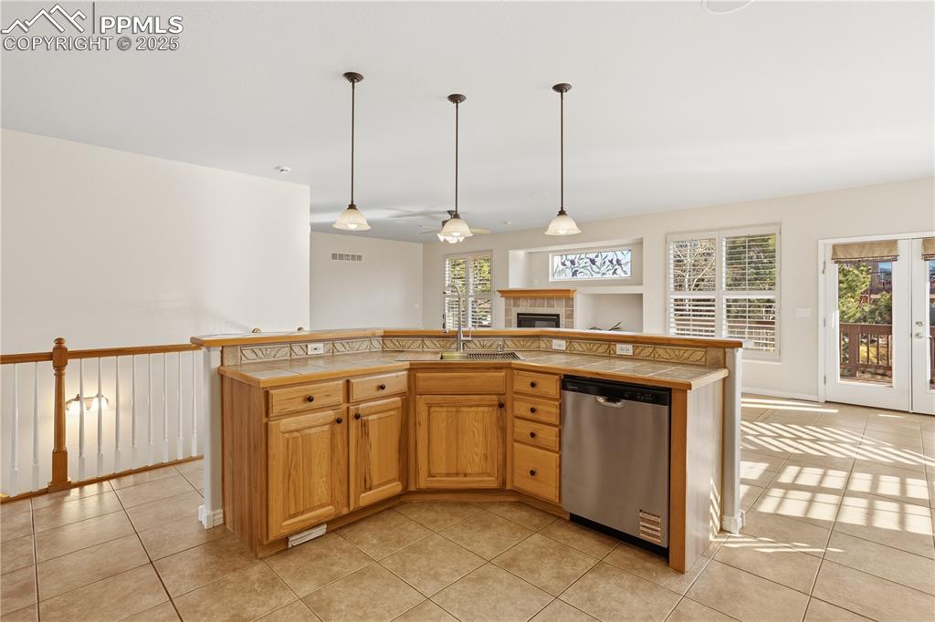 16243 Kitchener Way Monument, CO 80132 - Photo 7 of 33 a kitchen with stainless steel appliances granite countertop a sink and a stove