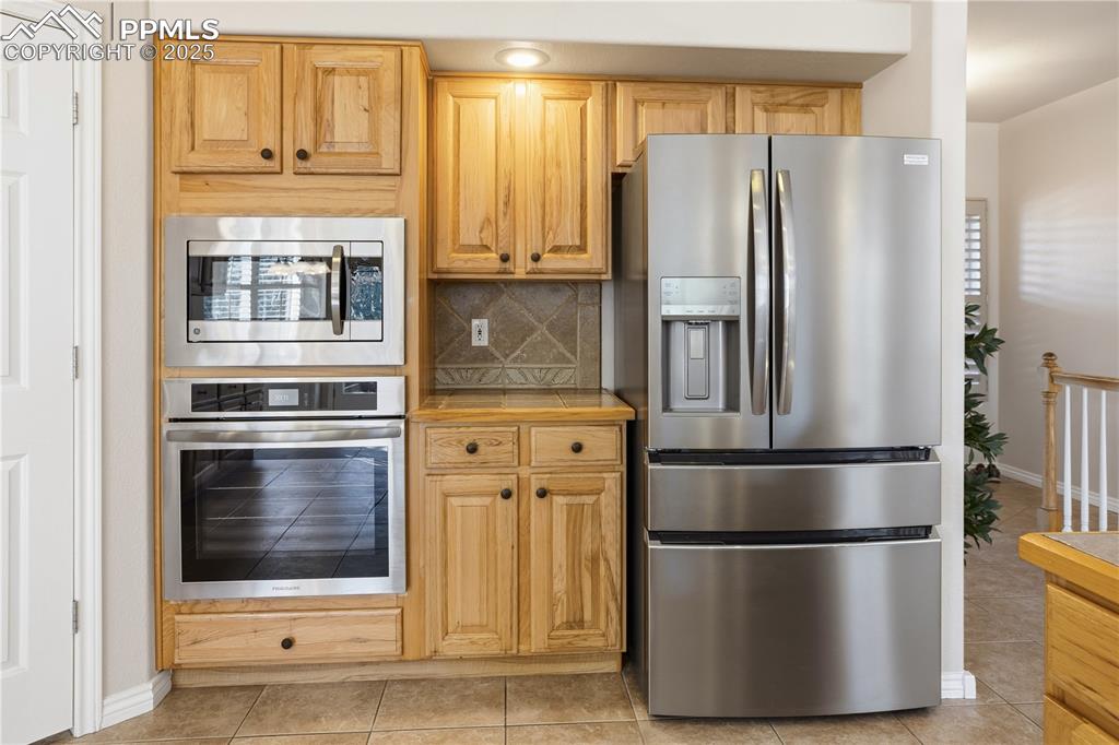 16243 Kitchener Way Monument, CO 80132 - Photo 8 of 33 a metallic refrigerator freezer and a stove sitting inside of a kitchen
