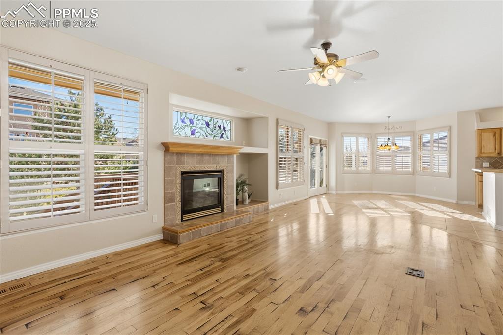 16243 Kitchener Way Monument, CO 80132 - Photo 10 of 33 a view of an empty room with wooden floor and a window