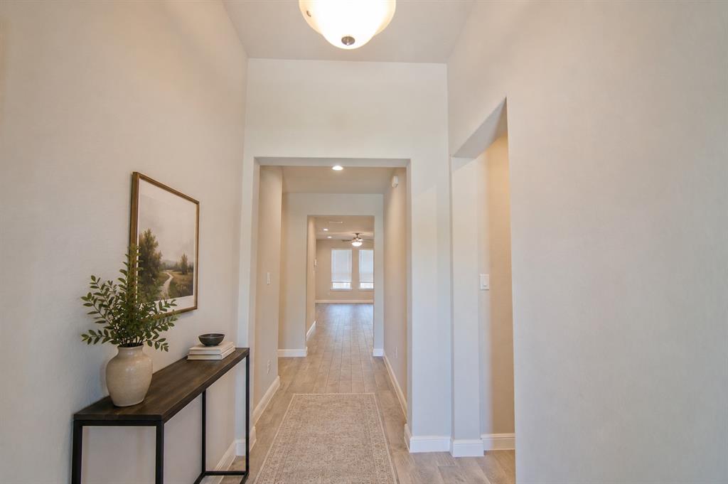 1804 Mensa Drive Haslet, TX 76052 - Photo 3 of 30 Long hallway featuring wood-finish flooring, recessed lighting, and neutral wall tones