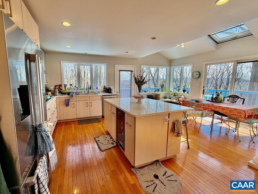 821 Gilliams Mountain Road Charlottesville, VA 22903 - Photo 12 of 40 a living room with stainless steel appliances granite countertop furniture wooden floor and a kitchen view