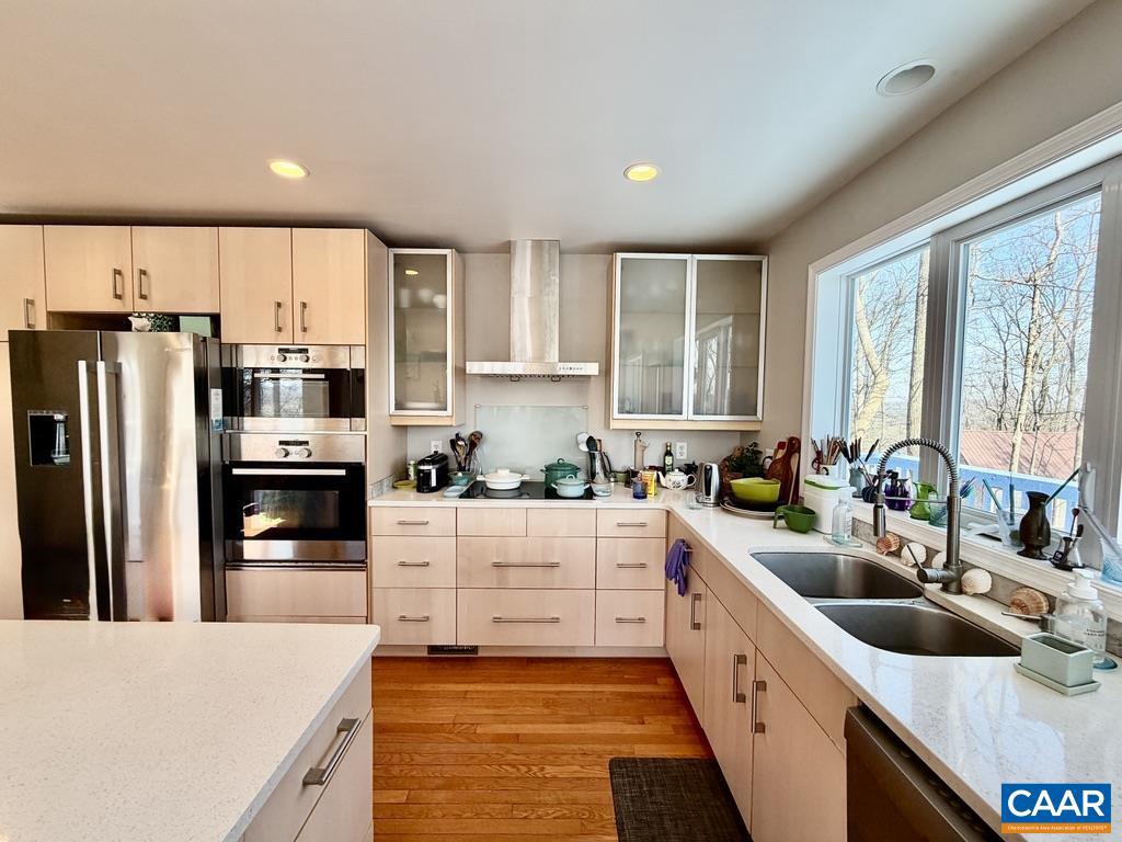 821 Gilliams Mountain Road Charlottesville, VA 22903 - Photo 13 of 40 a kitchen with stainless steel appliances a sink a stove a refrigerator cabinets and a window