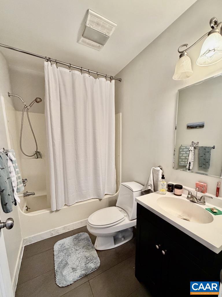 821 Gilliams Mountain Road Charlottesville, VA 22903 - Photo 18 of 40 a bathroom with a sink a toilet and shower curtain