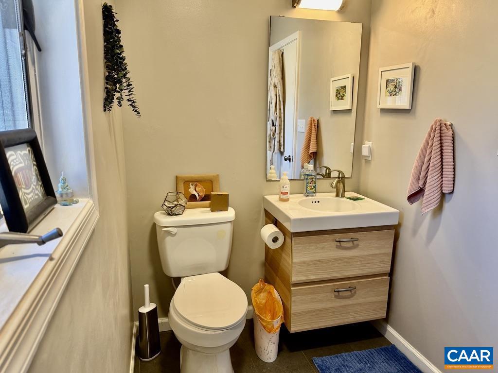 821 Gilliams Mountain Road Charlottesville, VA 22903 - Photo 26 of 40 a bathroom with a sink mirror vanity and toilet