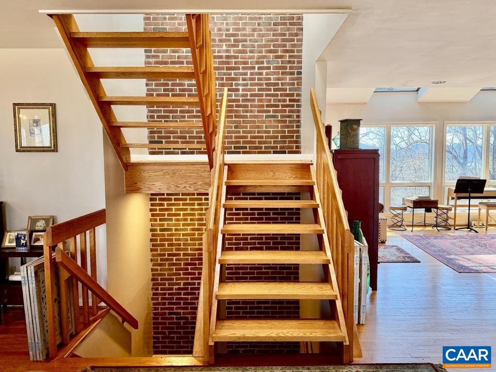 821 Gilliams Mountain Road Charlottesville, VA 22903 - Photo 5 of 40 a view of staircase with white walls and a window