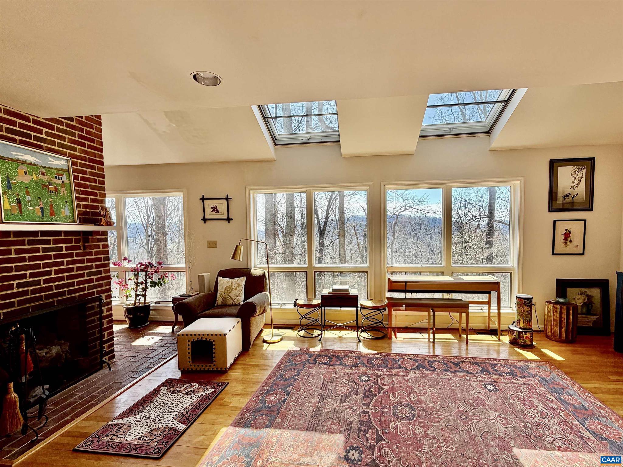 821 Gilliams Mountain Road Charlottesville, VA 22903 - Photo 6 of 40 a living room with furniture rug and a fireplace