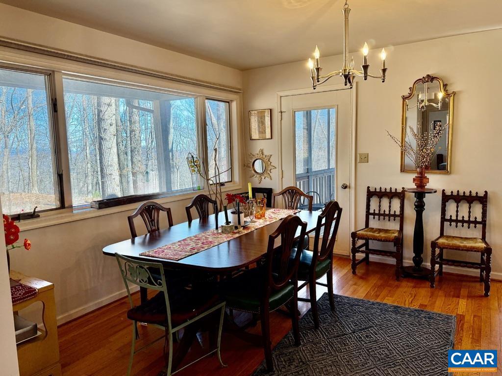 821 Gilliams Mountain Road Charlottesville, VA 22903 - Photo 10 of 40 a view of a dining room with furniture window and wooden floor