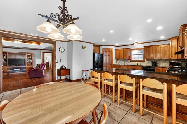 a large kitchen with a table and chairs