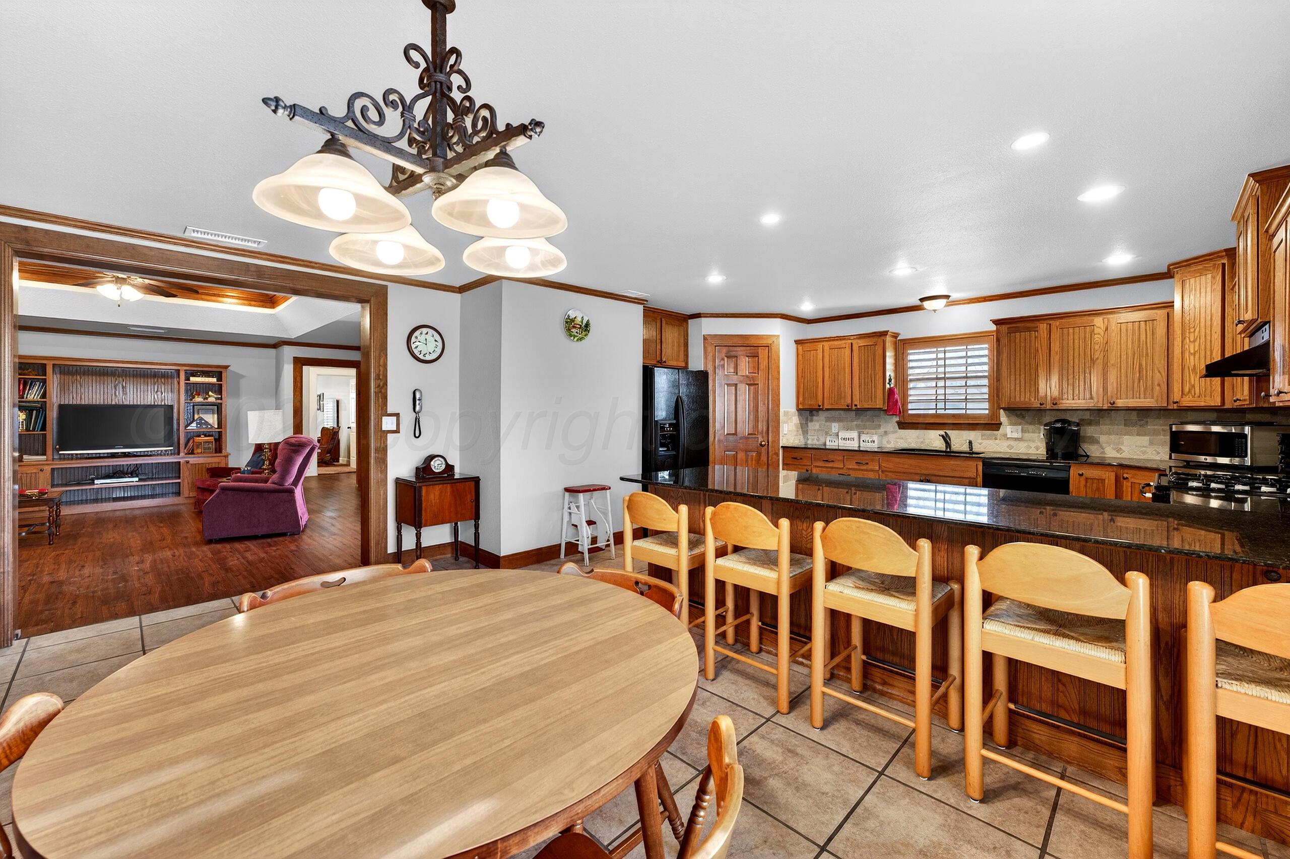 312 Dysart Street Claude, TX 79019 - Photo 17 of 37 a large kitchen with a table and chairs