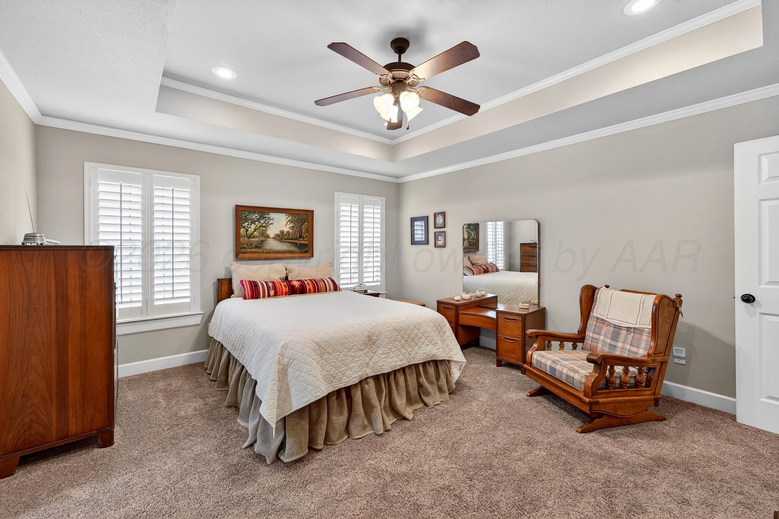 312 Dysart Street Claude, TX 79019 - Photo 19 of 37 a bed room with a bed and a chandelier