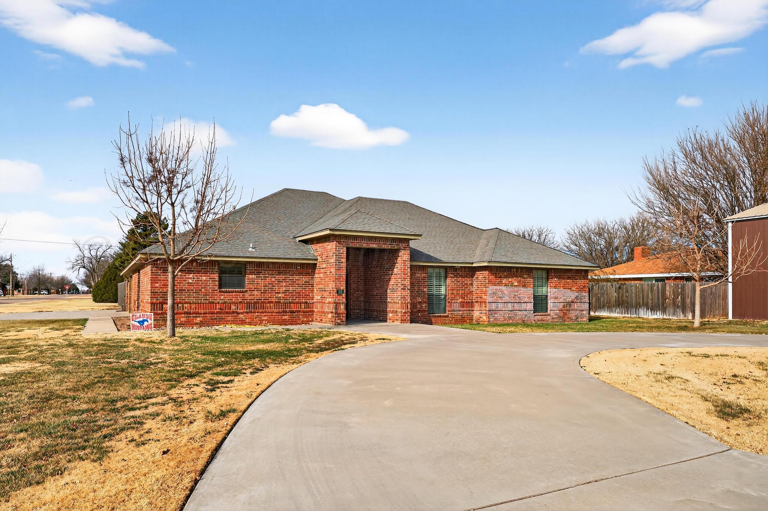 312 Dysart Street Claude, TX 79019 - Photo 2 of 37 a front view of a house with a yard and covered with snow