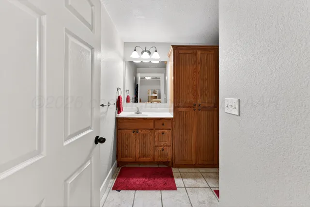 a bathroom with a sink vanity and mirror