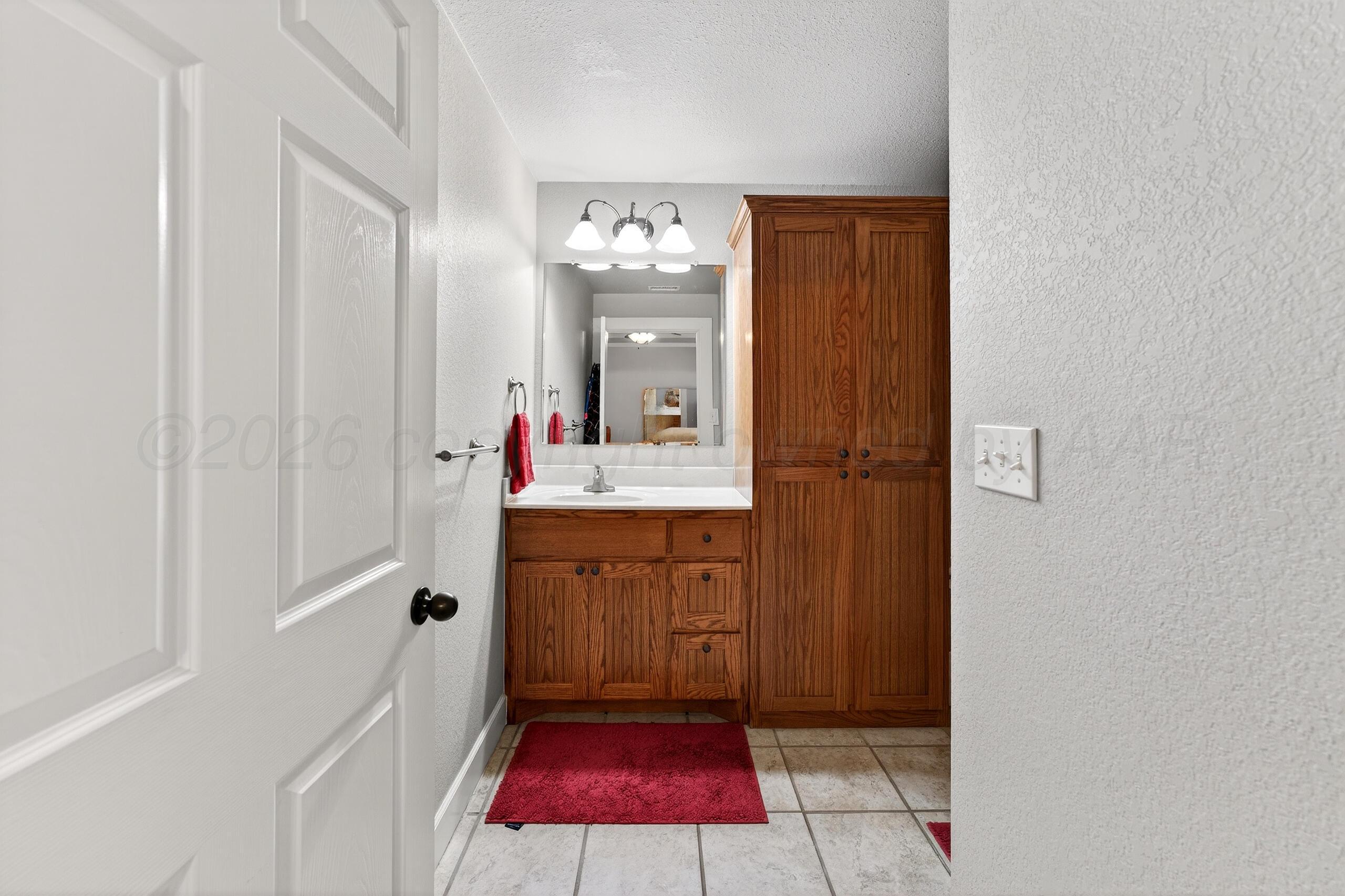 312 Dysart Street Claude, TX 79019 - Photo 21 of 37 a bathroom with a sink vanity and mirror