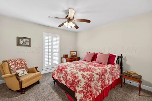 a bedroom with a bed couch and window