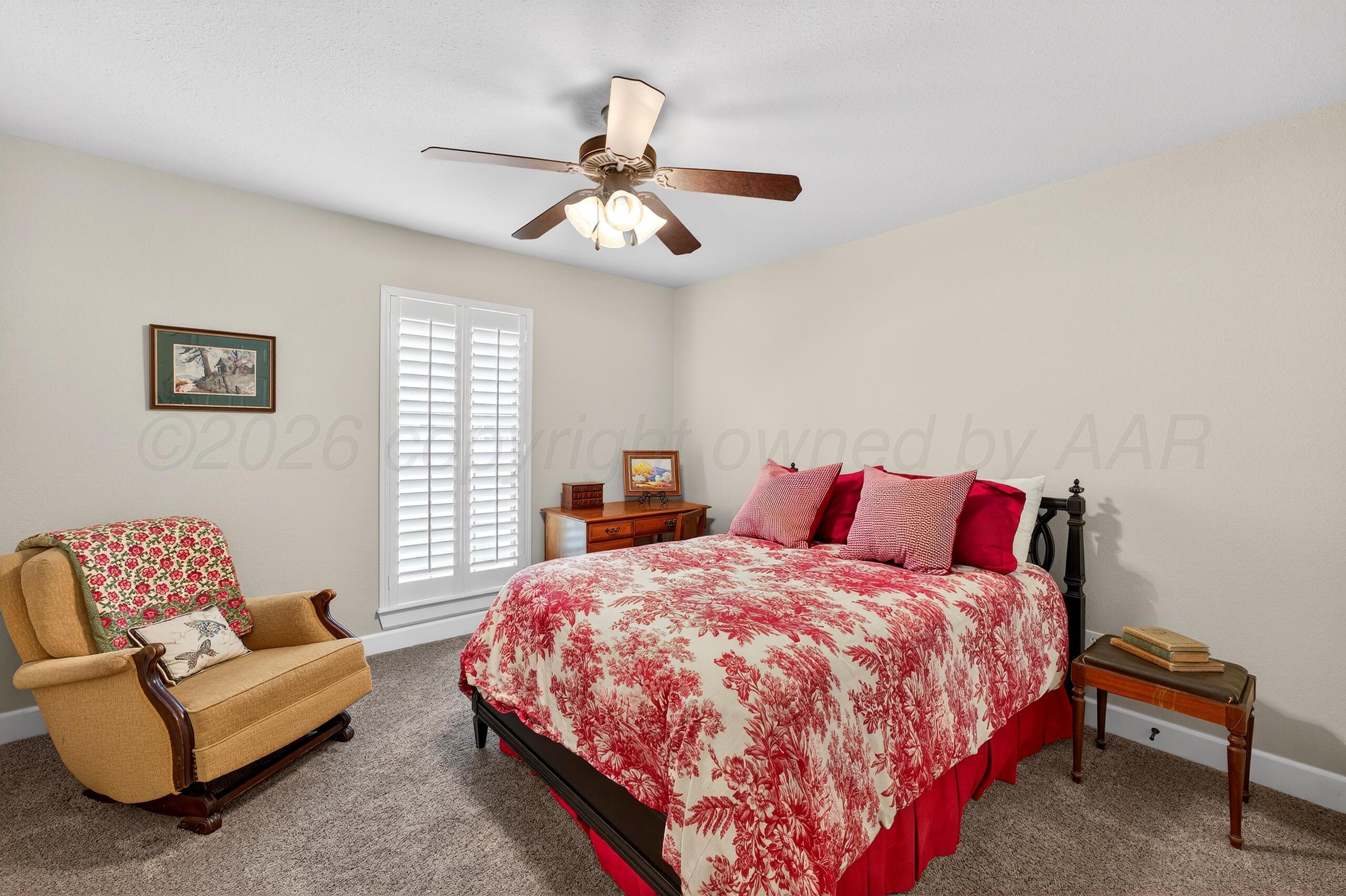 312 Dysart Street Claude, TX 79019 - Photo 25 of 37 a bedroom with a bed couch and window