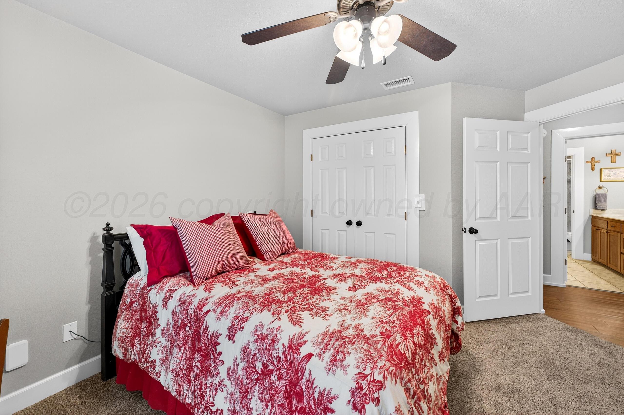 312 Dysart Street Claude, TX 79019 - Photo 26 of 37 a bedroom with a large bed and a chandelier