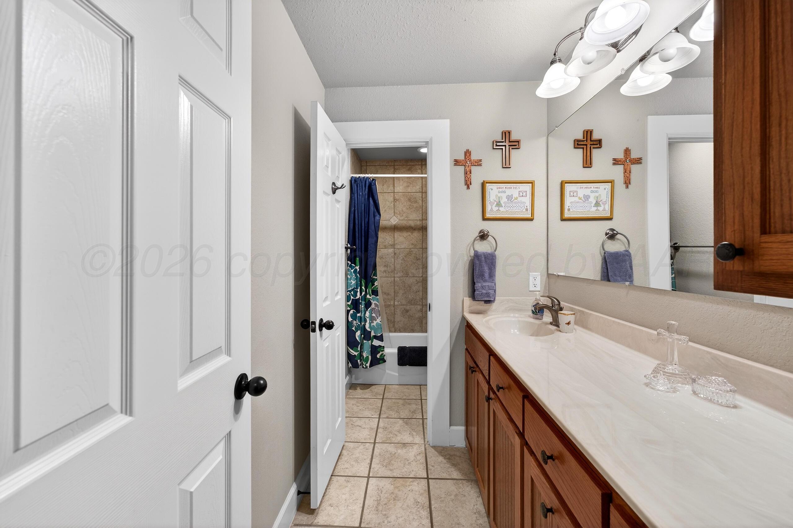 312 Dysart Street Claude, TX 79019 - Photo 27 of 37 a bathroom with a double vanity sink a toilet and shower