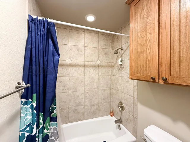 a bathroom with a toilet and shower