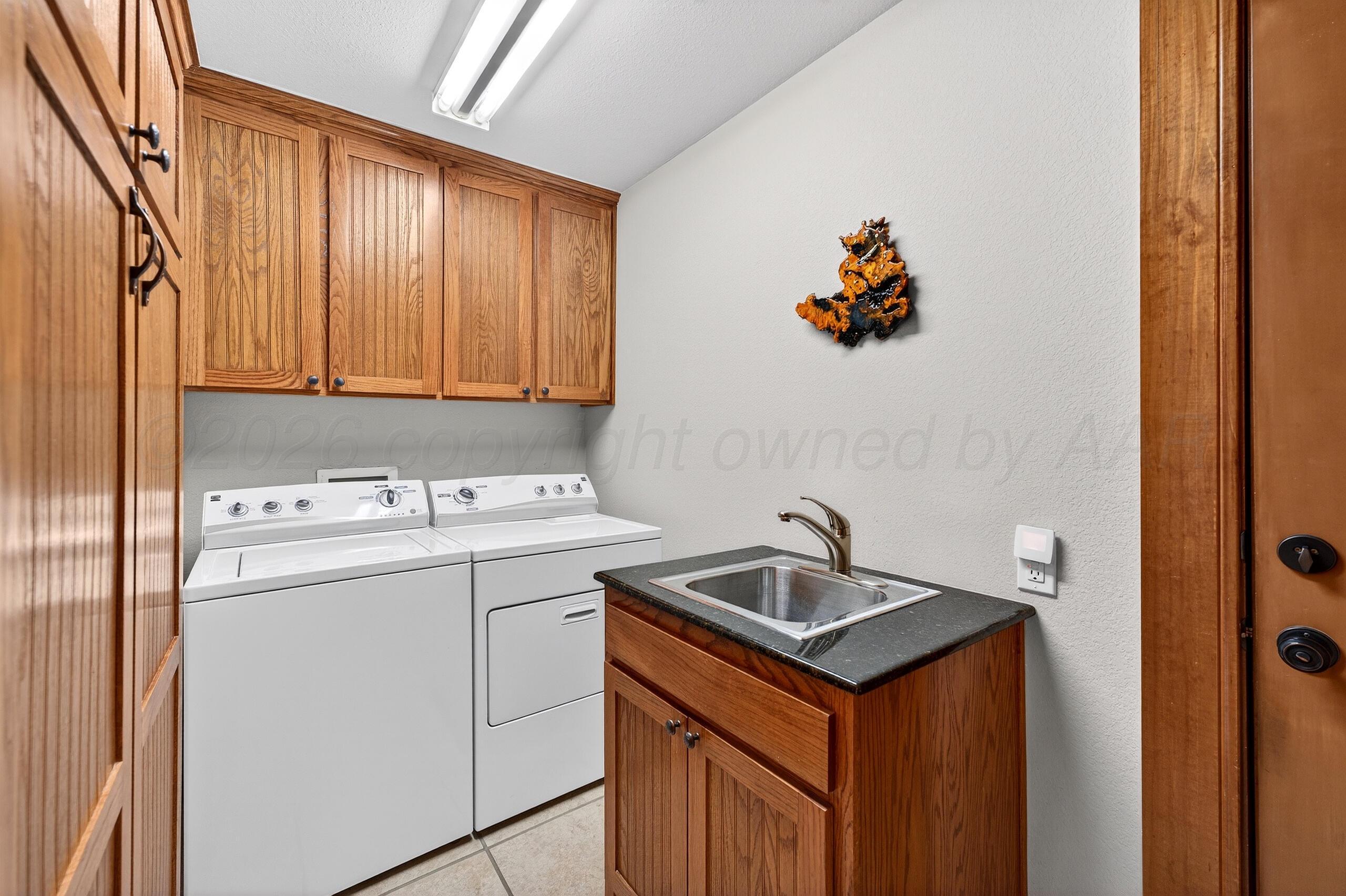 312 Dysart Street Claude, TX 79019 - Photo 33 of 37 a utility room with dryer and washer