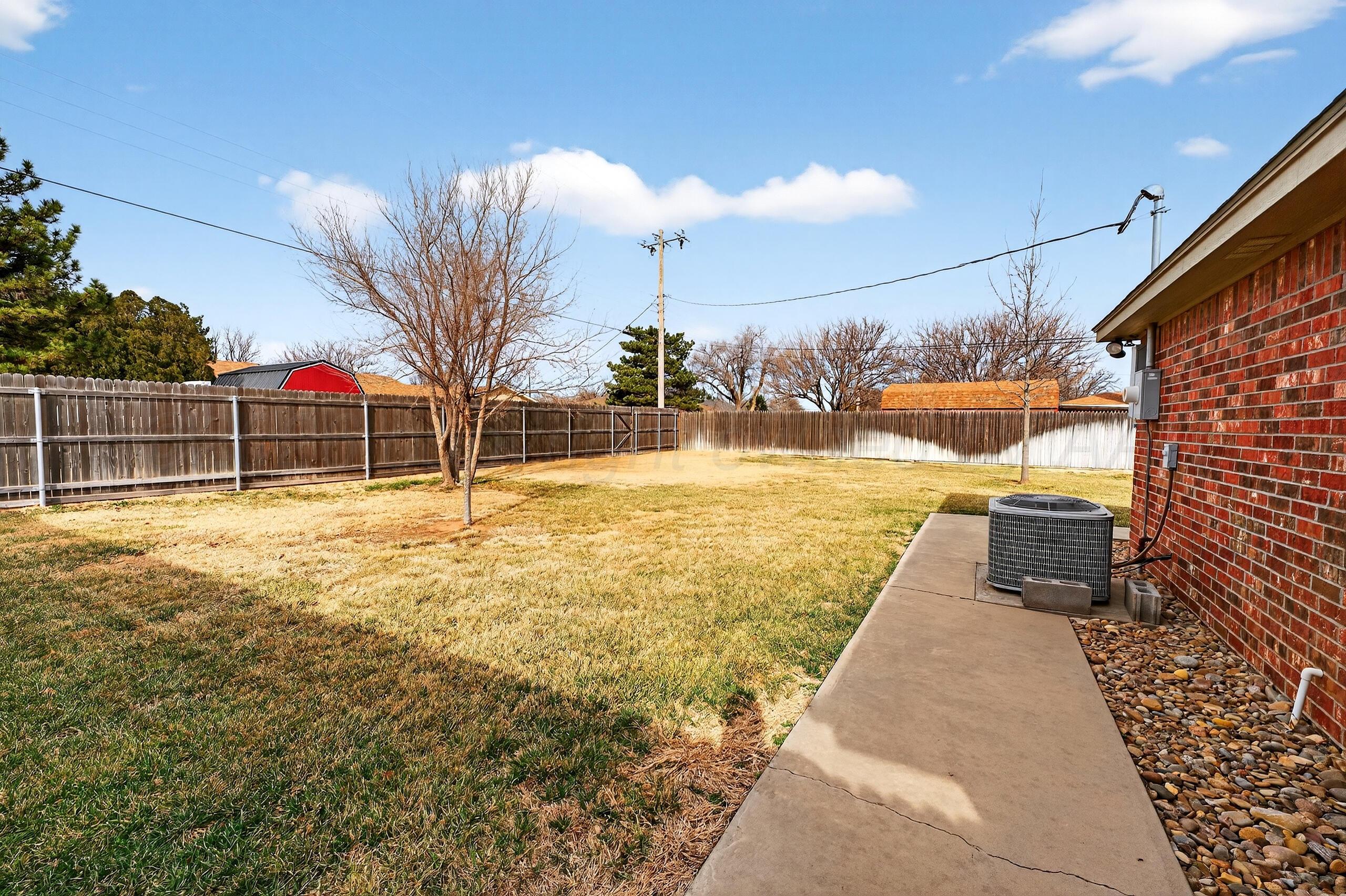 312 Dysart Street Claude, TX 79019 - Photo 36 of 37 a view of a swimming pool with a lawn chairs and a fire pit