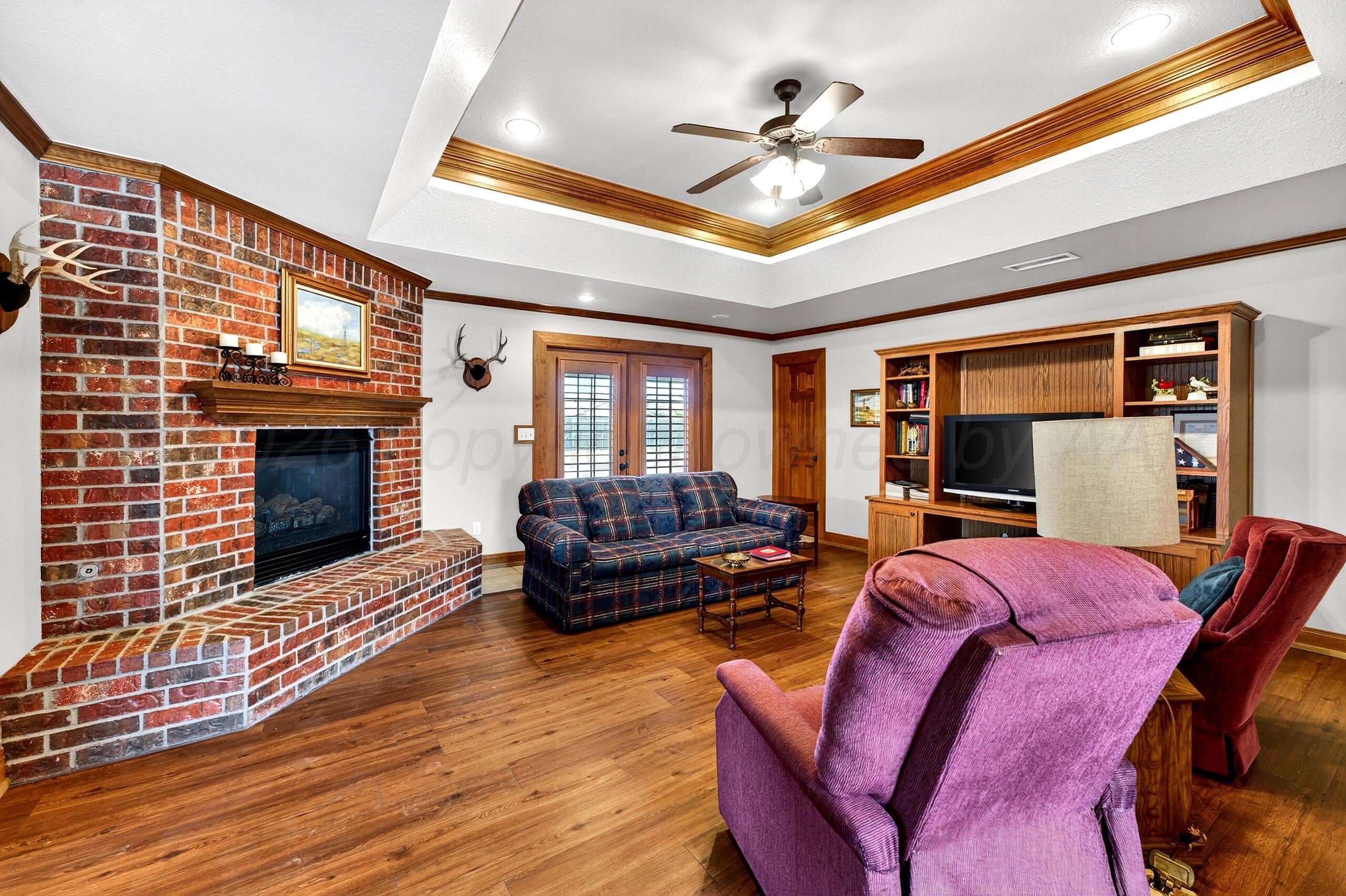 312 Dysart Street Claude, TX 79019 - Photo 5 of 37 a living room with furniture a fireplace and wooden floor