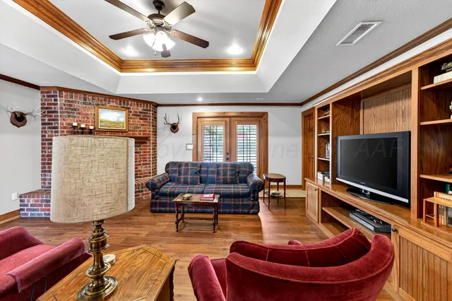 a living room with patio furniture and a flat screen tv