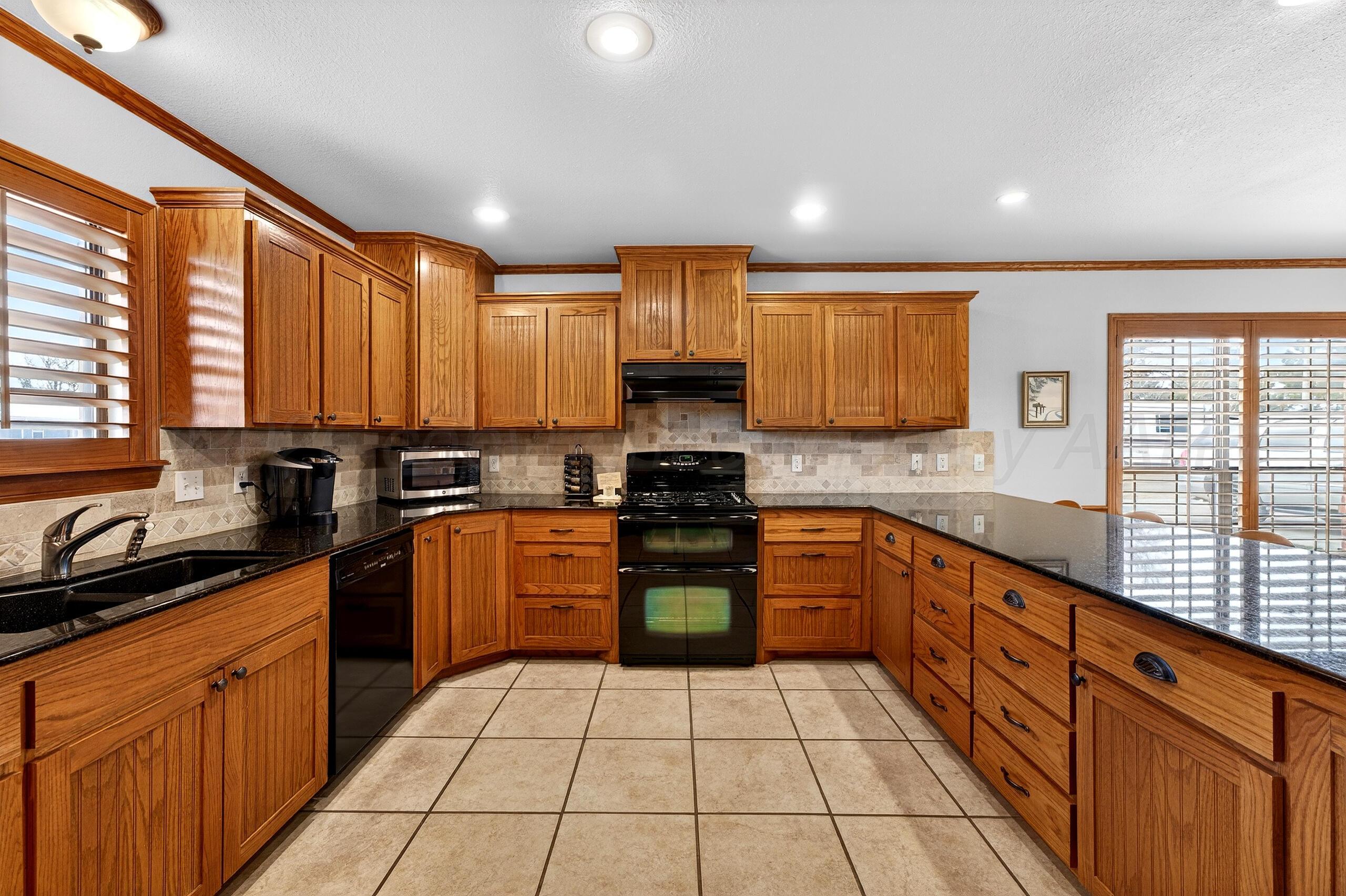 312 Dysart Street Claude, TX 79019 - Photo 8 of 37 a kitchen with stainless steel appliances granite countertop a stove sink and cabinets
