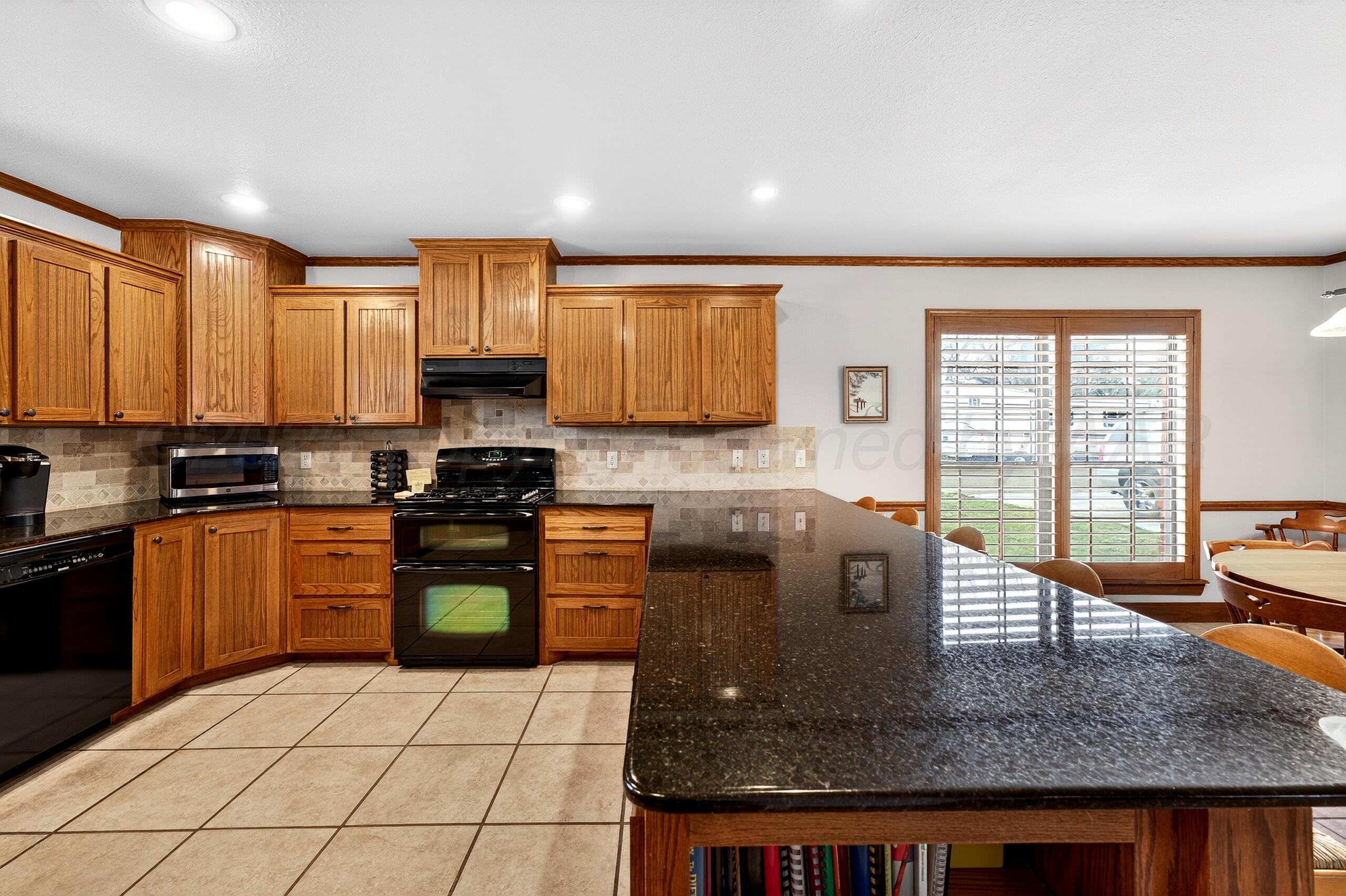 312 Dysart Street Claude, TX 79019 - Photo 10 of 37 a kitchen with stainless steel appliances granite countertop a stove sink and cabinets