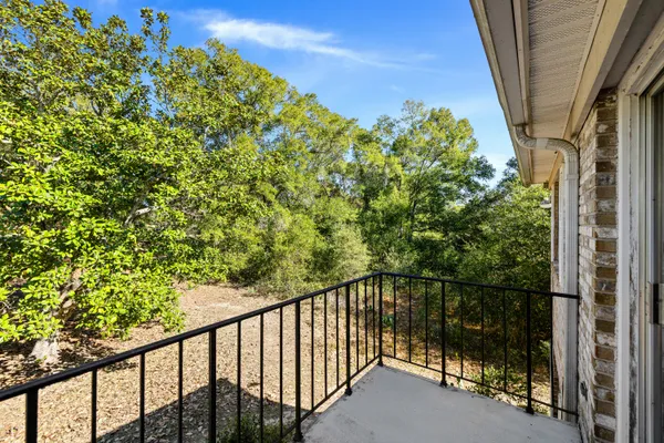 a view of a balcony with a tree