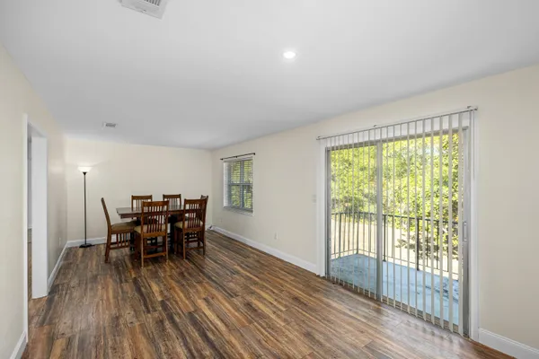 a view of a dining room with furniture and wooden floor