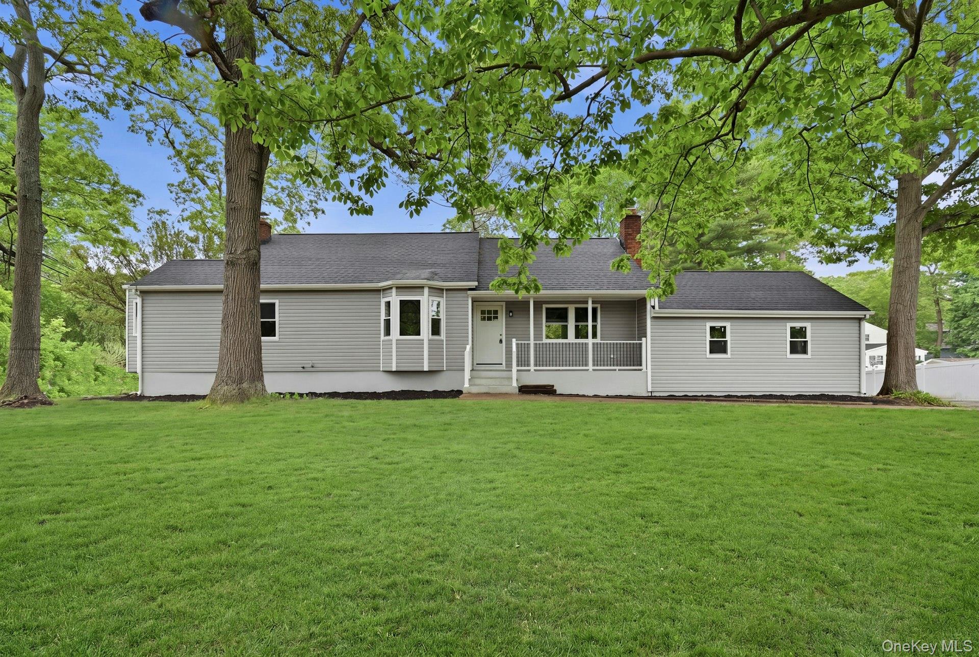 101 Rustic Road Centereach, NY 11720 - Photo 1 of 42 front view of a house with a yard