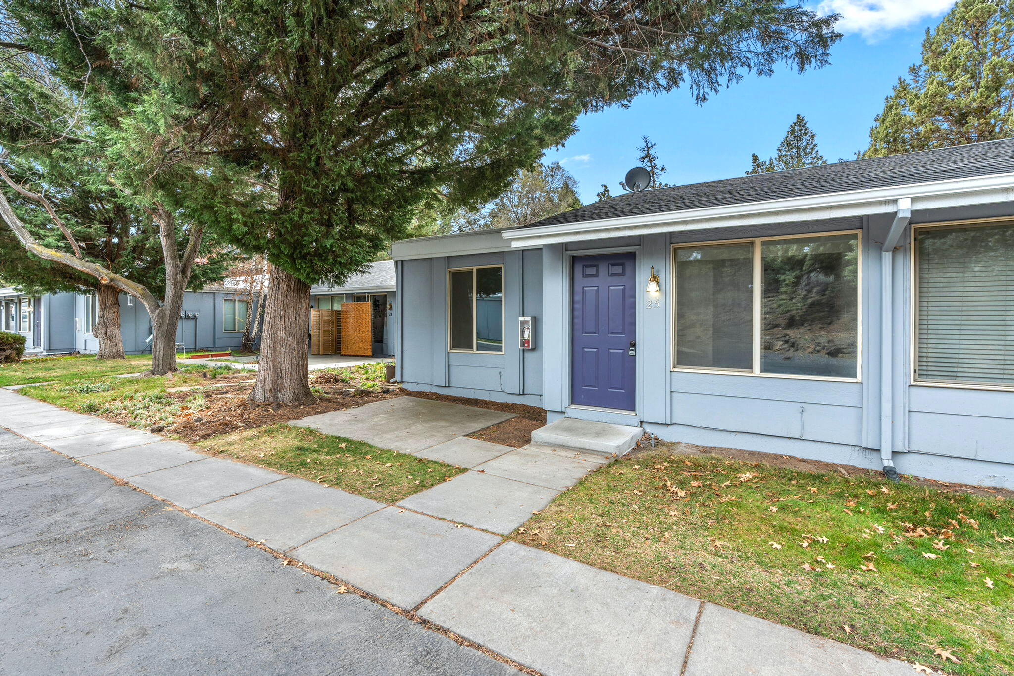 1700 Northeast Wells Acres Road, Unit 25 Bend, OR 97701 - Photo 3 of 25 a view of a house with a backyard and a tree