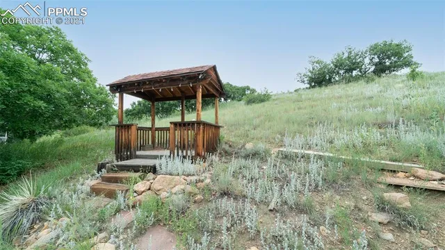 a backyard of a house with table and chairs