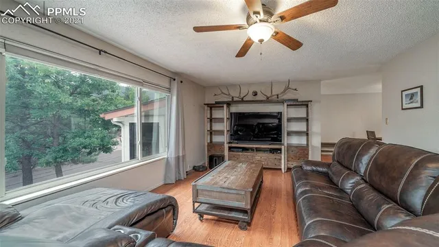 a bedroom with a bed window and a mirror on the dresser