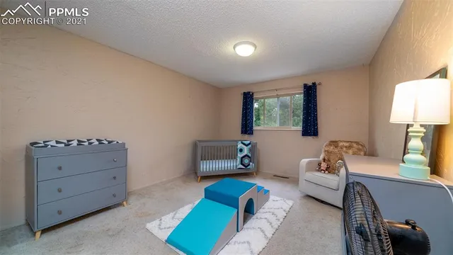 a workspace with furniture hardwood floor and a window