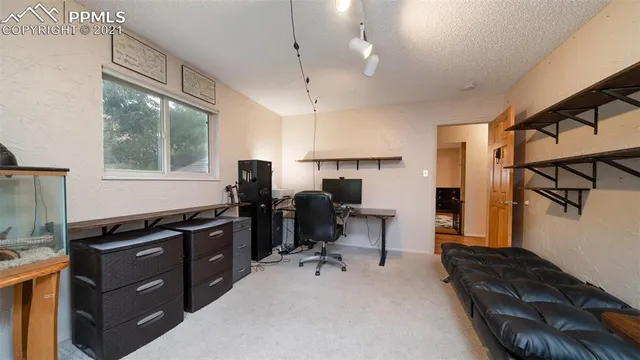 a bathroom with a toilet a sink a mirror a window and vanity