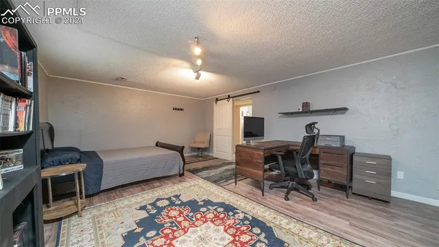 a bedroom with a bed and a television