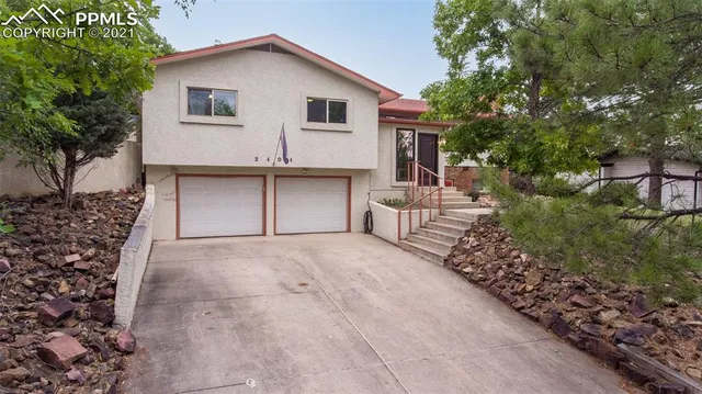 a view of a house with a yard and garage
