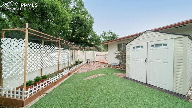 a view of a house with a yard and plants