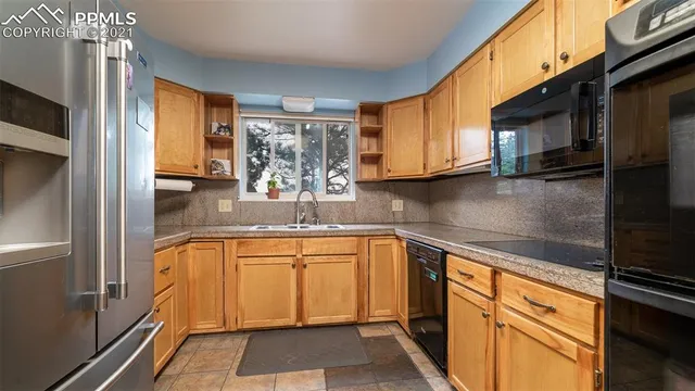 a kitchen with stainless steel appliances granite countertop a sink and cabinets