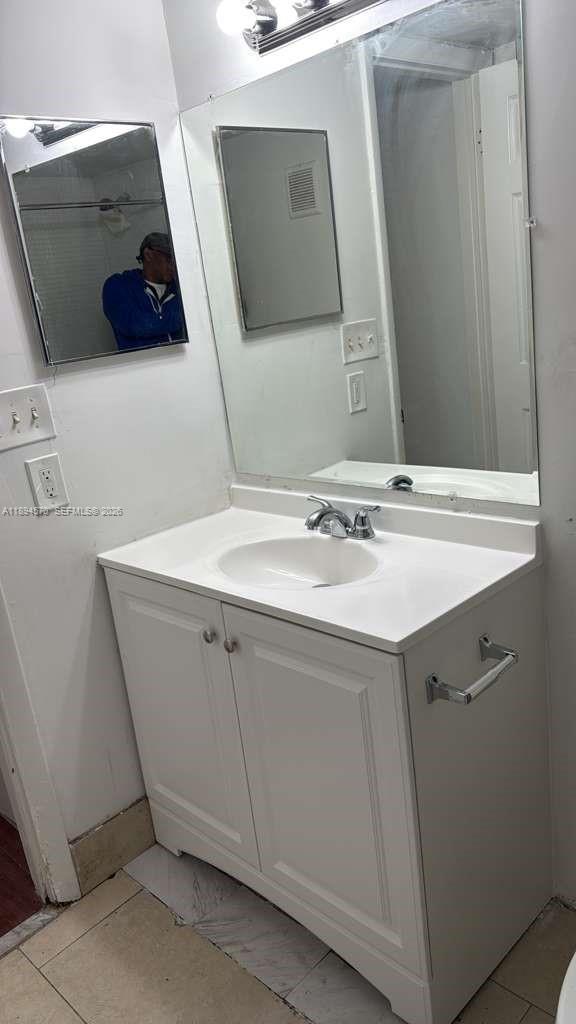 2029 Northwest 46th Avenue, Unit E107 Lauderhill, FL 33313 - Photo 11 of 12 a bathroom with a sink and a mirror