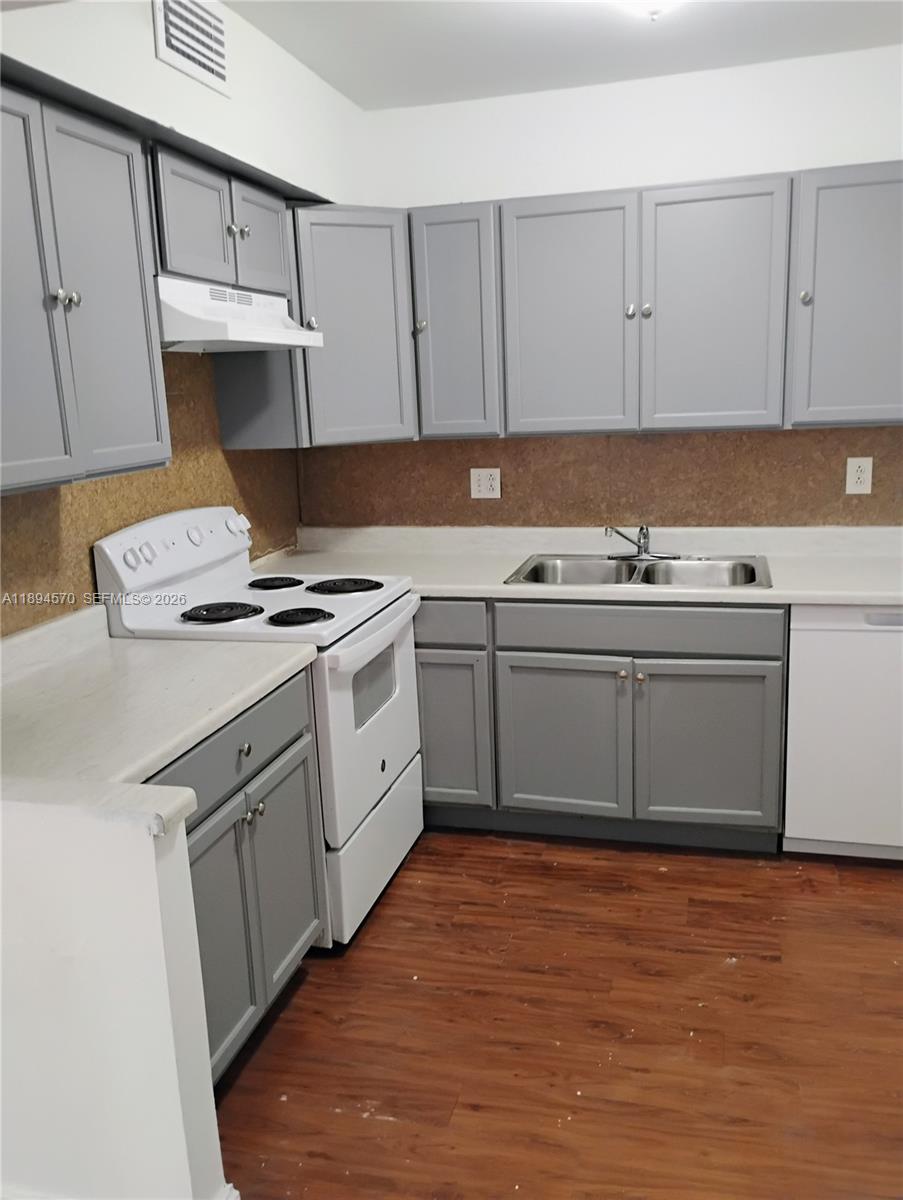 2029 Northwest 46th Avenue, Unit E107 Lauderhill, FL 33313 - Photo 2 of 12 a kitchen with stainless steel appliances granite countertop a stove sink and cabinets