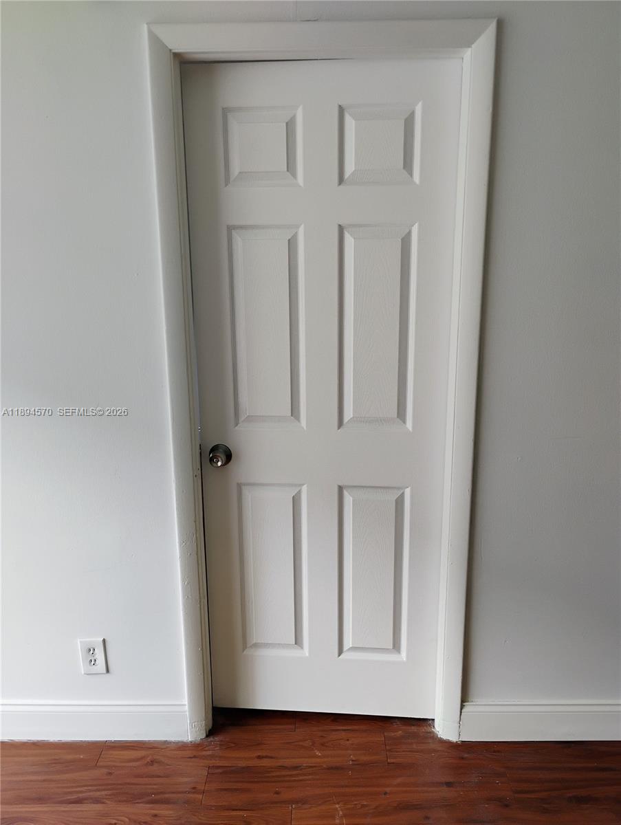 2029 Northwest 46th Avenue, Unit E107 Lauderhill, FL 33313 - Photo 7 of 12 a view of front door with wooden floor
