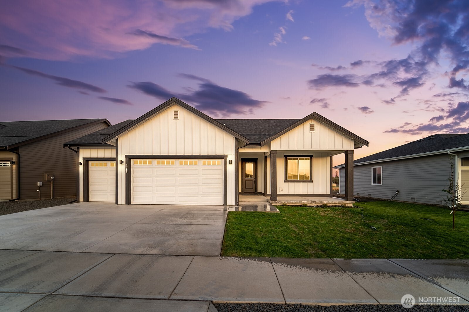 a front view of a house with a yard and garage