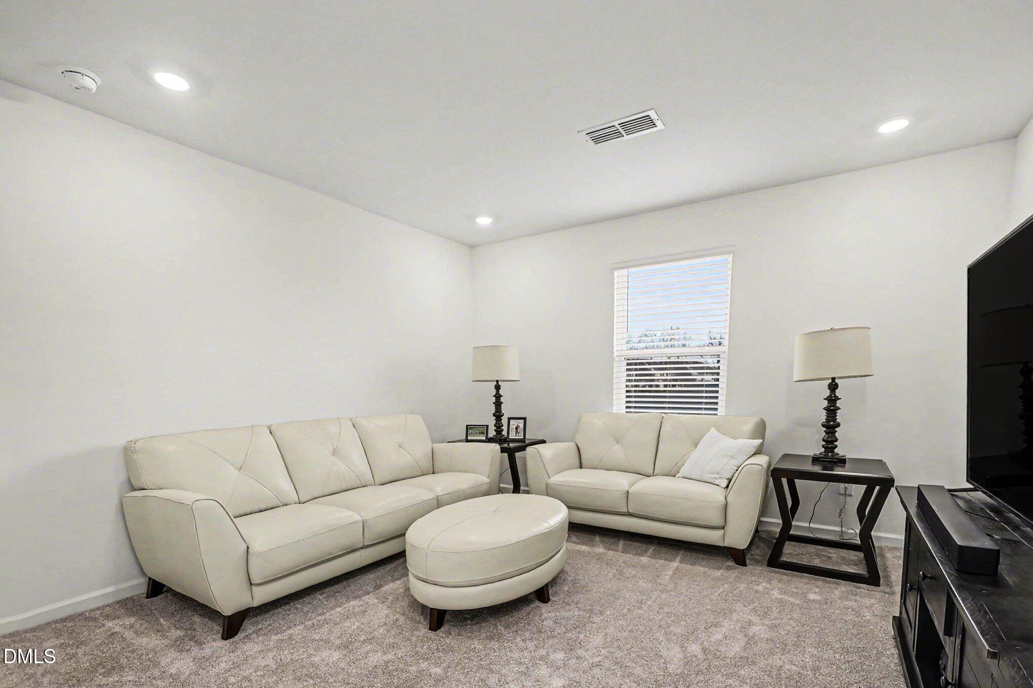 2732 Princess Tree Drive Raleigh, NC 27616 - Photo 10 of 32 a living room with furniture and a flat screen tv