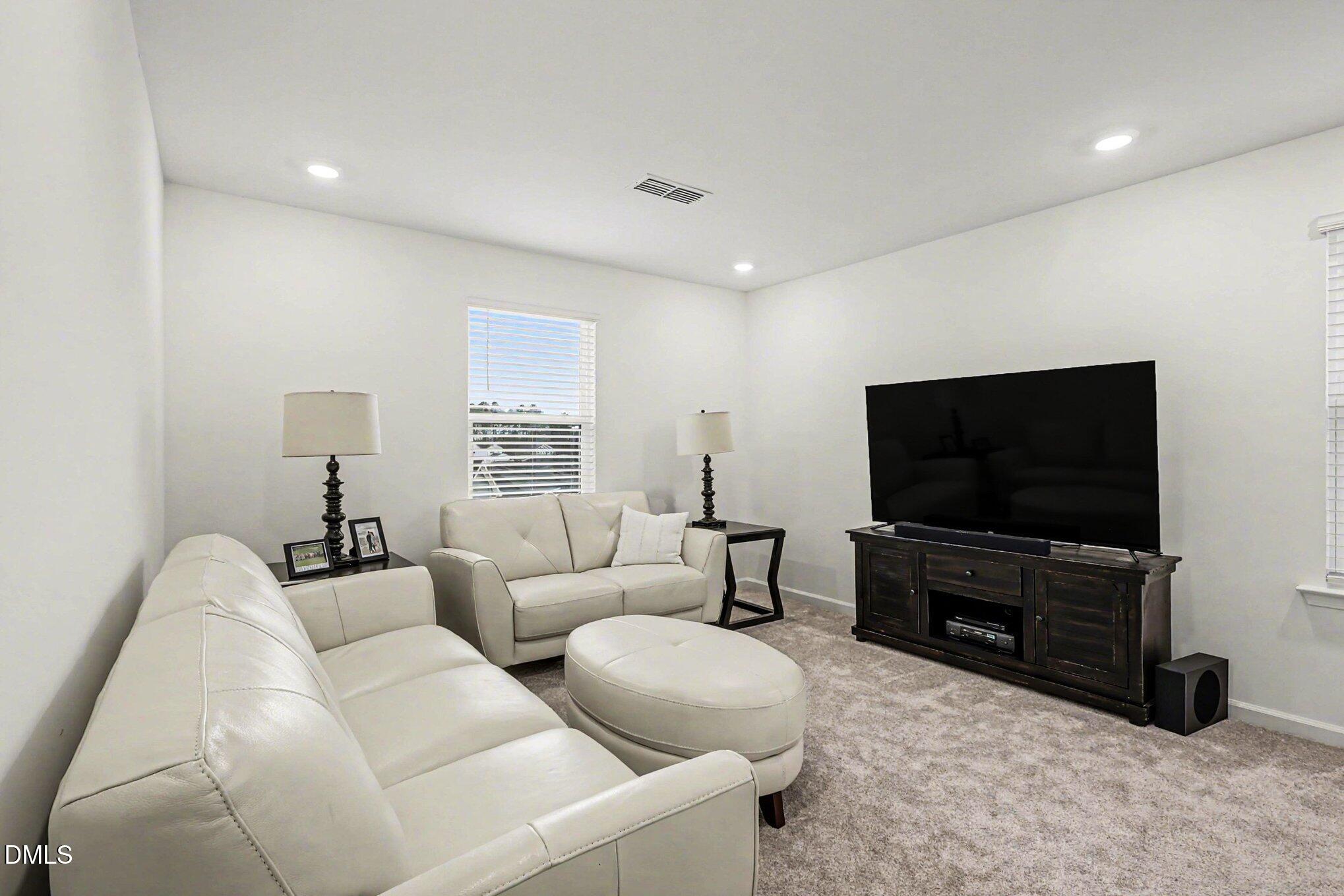 2732 Princess Tree Drive Raleigh, NC 27616 - Photo 11 of 32 a living room with furniture and a flat screen tv