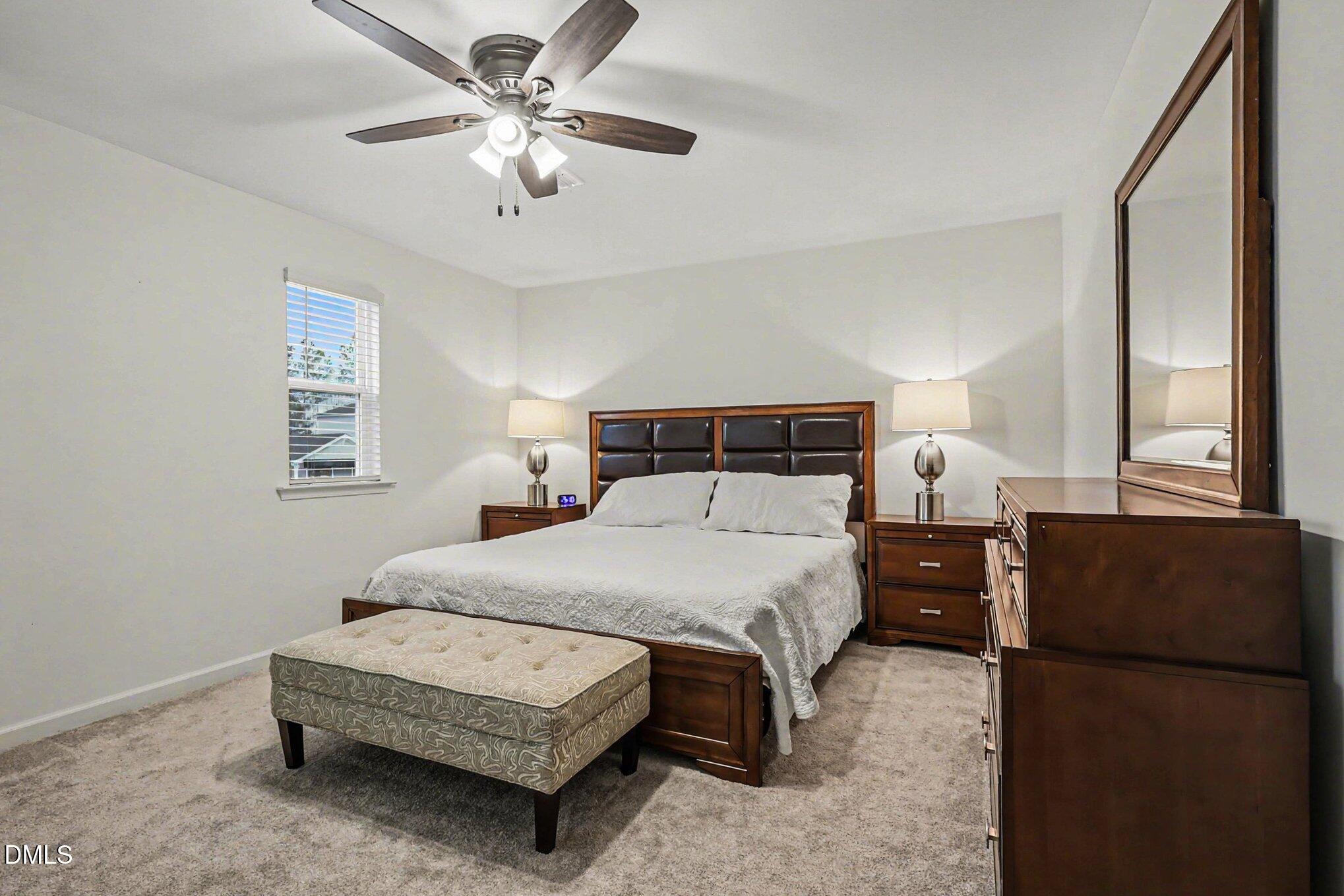 2732 Princess Tree Drive Raleigh, NC 27616 - Photo 12 of 32 a bedroom with a bed window and a chandelier